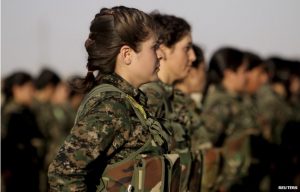 Women of the YPJ stand at attention.