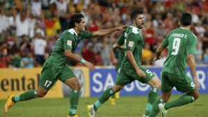 Iraq's Yaser Safa Kasim celebrates his goal with team mates Alaa Abdulzehra and Ahmed Yaseen Gheni during their Asian Cup Group D soccer match against Jordan at the Brisbane Stadium in Brisbane