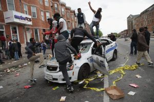 Rioters in Baltimore destroying police car. 