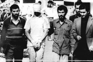 FILE - In this Nov. 9, 1979, file photo, one of the hostages being held at the U.S. Embassy in Tehran is displayed to the crowd, blindfolded and with his hands bound, outside the embassy. Fifty-two of the hostages endured 444 days of captivity. Former Iranian hostages had varied reactions to the news of the nuclear deal between the U.S. and Iran in what is being billed as a trust-building agreement designed to yield a more comprehensive deal six months from now. (AP Photo/File)