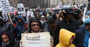 A collection of elected officials, community activists and labor leaders listen to a prayer before a demonstration billed as a "march for justice" along Michigan Avenue in Chicago on Friday, Nov. 27, 2015, in the wake of the release of video showing an officer fatally shooting Laquan McDonald. (Chris Walker/Chicago Tribune/TNS via Getty Images)