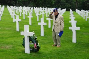 WWII Veteran salutes a fallen friend at Normandy