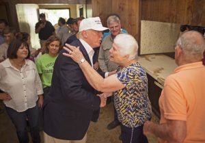 Republican presidential candidate Donald Trump, center, comforts flood victim Olive Gordan with her husband Jimmy, right, during tour of their flood damaged home in Denham Springs, La., Friday, Aug. 19, 2016. (AP Photo/Max Becherer) ORG XMIT: LAMB118