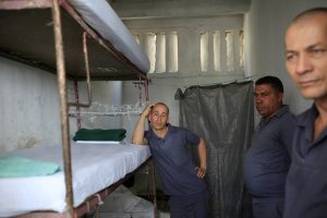 Three prisoners stand in their cell in the Combinado del Este prison during a media tour in Havana, Cuba, Tuesday, April 9, 2013. Cuban authorities led foreign journalists through the maximum security prison, the largest in the Caribbean country that houses 3,000 prisoners. Cuba says they have 200 prisons across the country, including five that are maximum security. (AP Photo/Franklin Reyes)