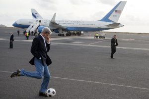U.S. Secretary of State John Kerry kicks a soccer ball around during an airplane refueling stop at Sal Island, Cape Verde, en route to Washington, DC, May 5, 2014.