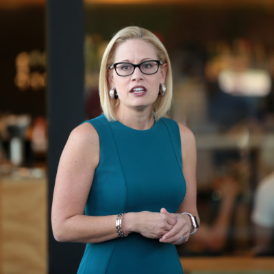 Kyrsten Sinema Is All Thumbs and Cake, Breaks Internet